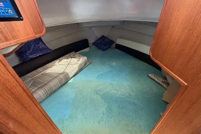 Slide: The Image of 2016 Ranger Tugs R-27 cabin interior with cozy bedding and wooden accents. - 30