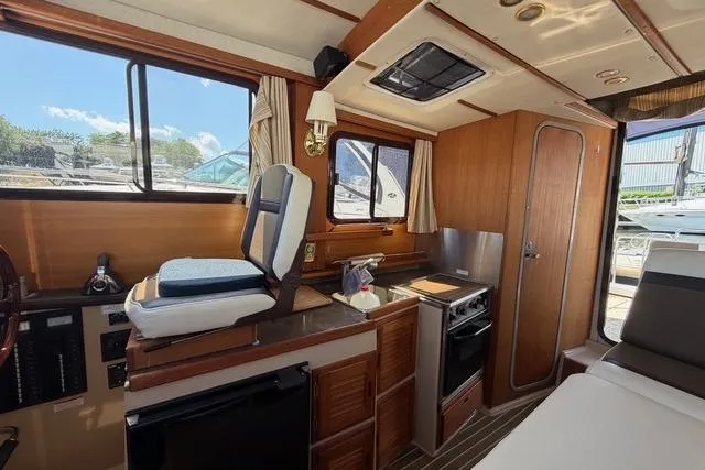 Slide: The Image of Interior of 2016 Ranger Tugs R-27 boat with kitchen and seating area. - 31