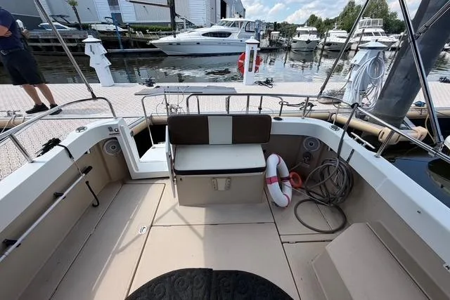 Slide: The Image of 2016 Ranger Tugs R-27 boat docked, featuring spacious deck and seating area. - 9