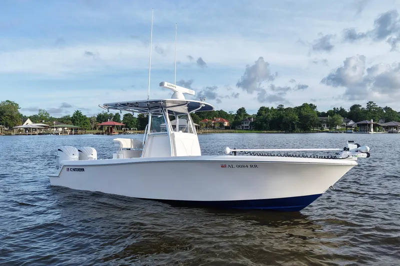 Slide: The Image of 2022 Contender 28 Tournament boat on calm water, surrounded by scenic shoreline. - 11