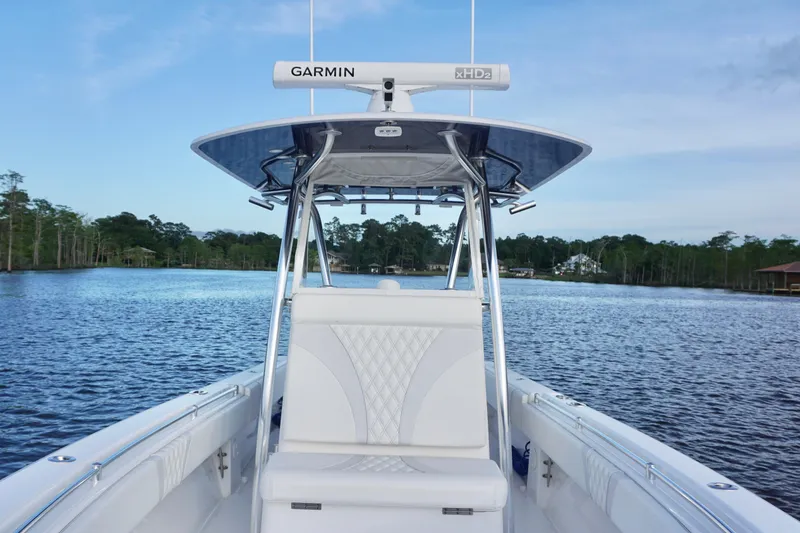 Slide: The Image of 2022 Contender 28 Tournament boat on a serene lake with lush greenery. - 16