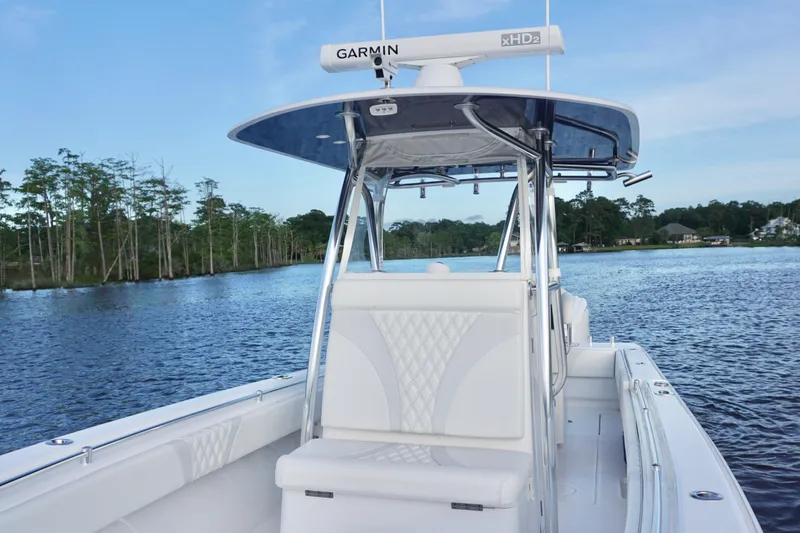 Slide: The Image of 2022 Contender 28 Tournament boat on a serene lake with lush greenery. - 17