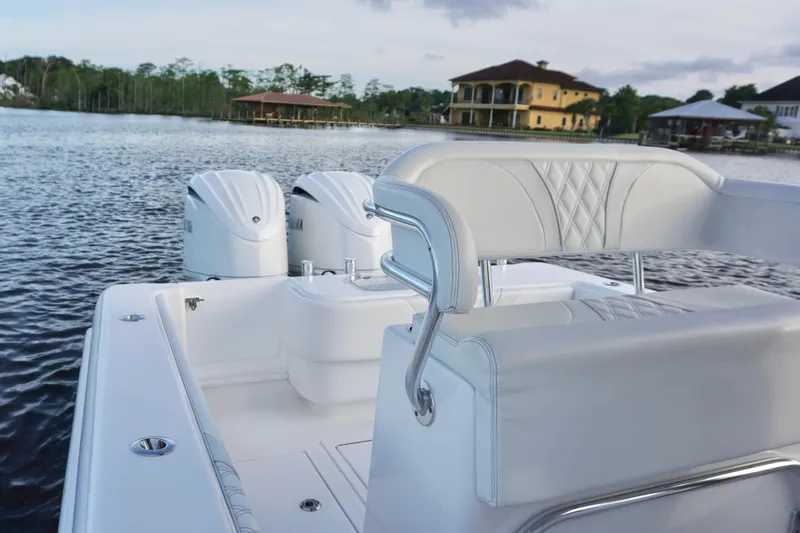 Slide: The Image of 2022 Contender 28 Tournament boat with dual engines on a serene lake. - 20