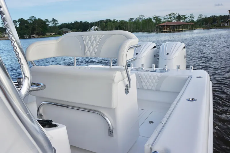 Slide: The Image of 2022 Contender 28 Tournament boat with sleek white seating and powerful engines on a serene lake. - 21