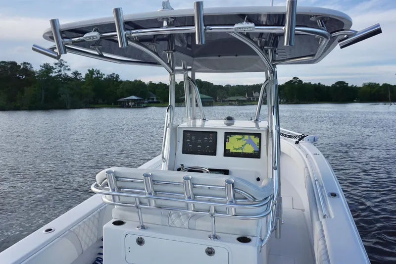 Slide: The Image of 2022 Contender 28 Tournament boat on a serene lake with advanced navigation system. - 22
