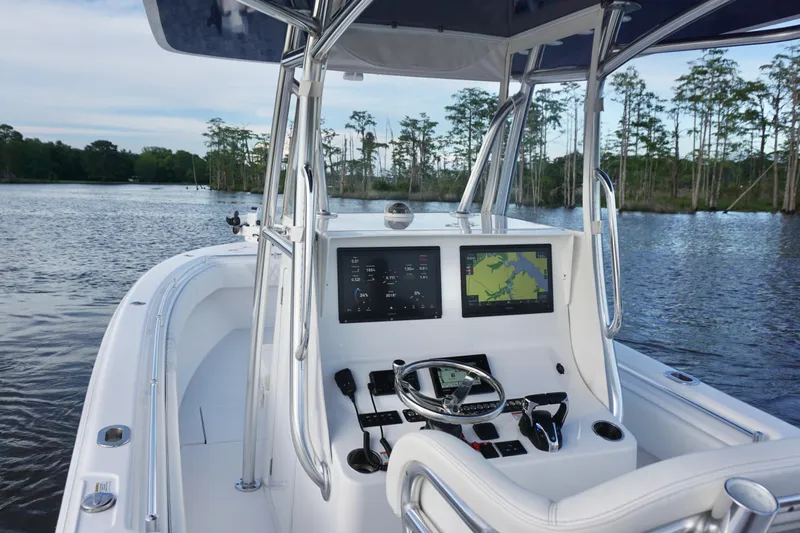 Slide: The Image of 2022 Contender 28 Tournament boat dashboard with navigation screens on a serene lake. - 23