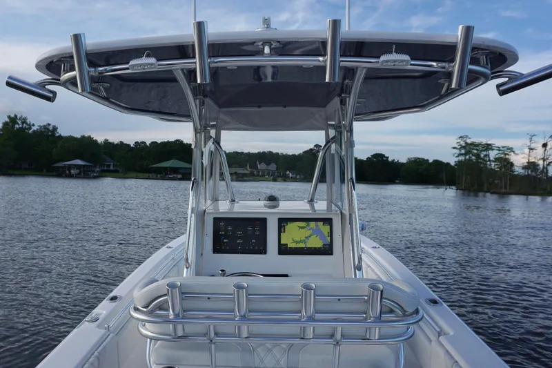 Slide: The Image of 2022 Contender 28 Tournament boat on a serene lake with navigation display. - 24