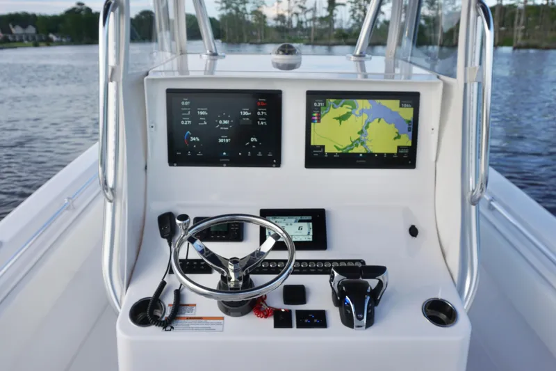 Slide: The Image of Center console of 2022 Contender 28 Tournament boat with navigation screens and controls. - 25