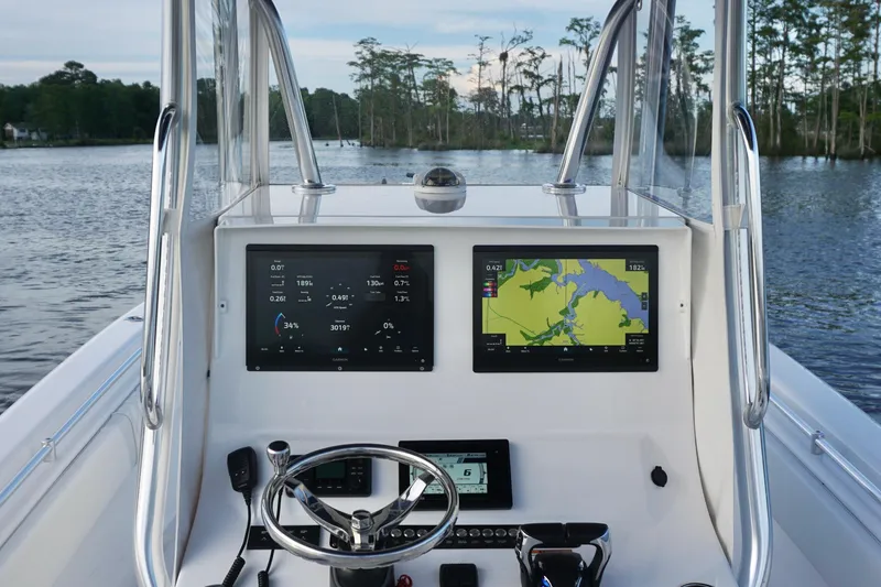 Slide: The Image of 2022 Contender 28 Tournament boat dashboard with navigation screens on a calm lake. - 26