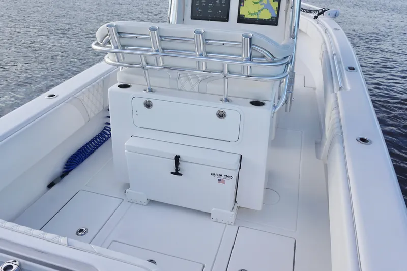 Slide: The Image of 2022 Contender 28 Tournament boat interior with console and storage on calm water. - 27