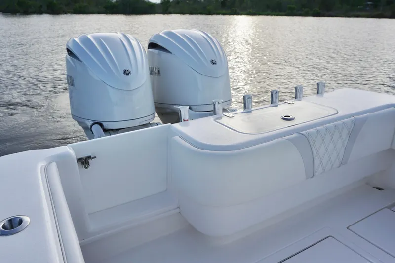 Slide: The Image of 2022 Contender 28 Tournament boat with dual outboard engines on a calm lake. - 29