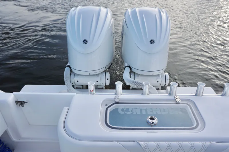 Slide: The Image of 2022 Contender 28 Tournament boat with dual outboard engines on water. - 30
