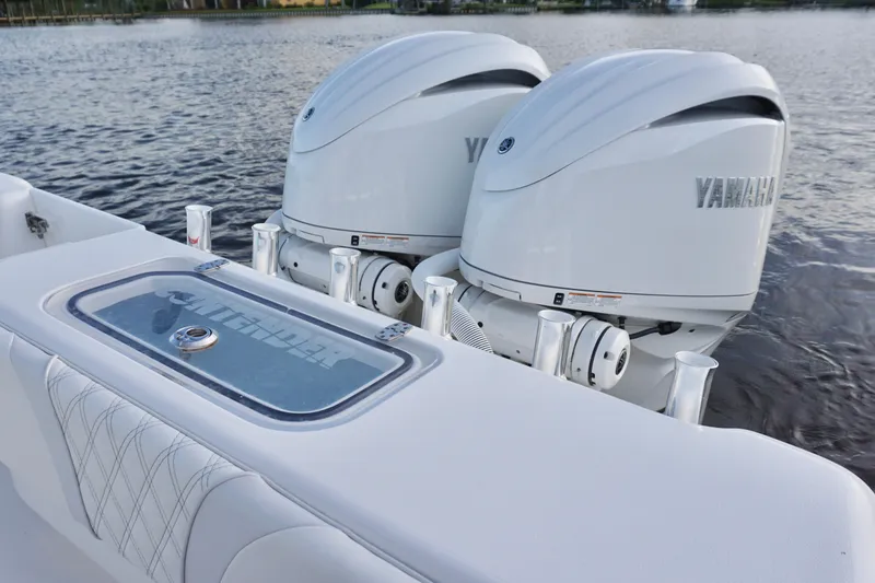 Slide: The Image of 2022 Contender 28 Tournament boat with dual Yamaha outboard engines on a calm lake. - 32