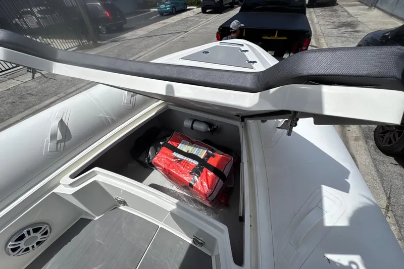 Slide: The Image of Open storage compartment on 2026 Northstar Orion 7 boat, revealing safety equipment. - 7