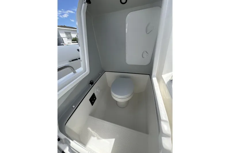 Slide: The Image of Compact marine bathroom in 2026 Northstar Orion 7 boat, featuring a toilet and storage compartment. - 9
