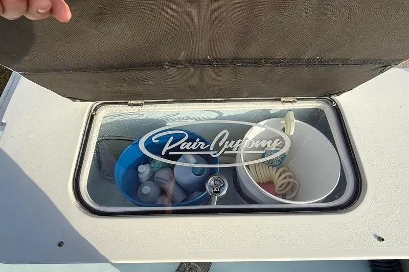 Slide: The Image of Pair Customs 24 Center Console DV 2023 storage compartment with cleaning supplies and accessories. - 11