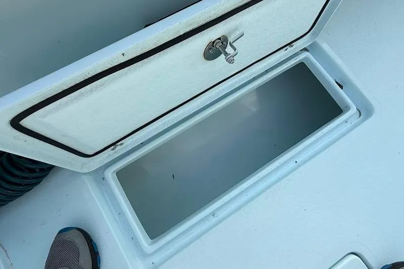 Slide: The Image of Open storage compartment on 2023 Pair Customs 24 Center Console DV boat. - 12