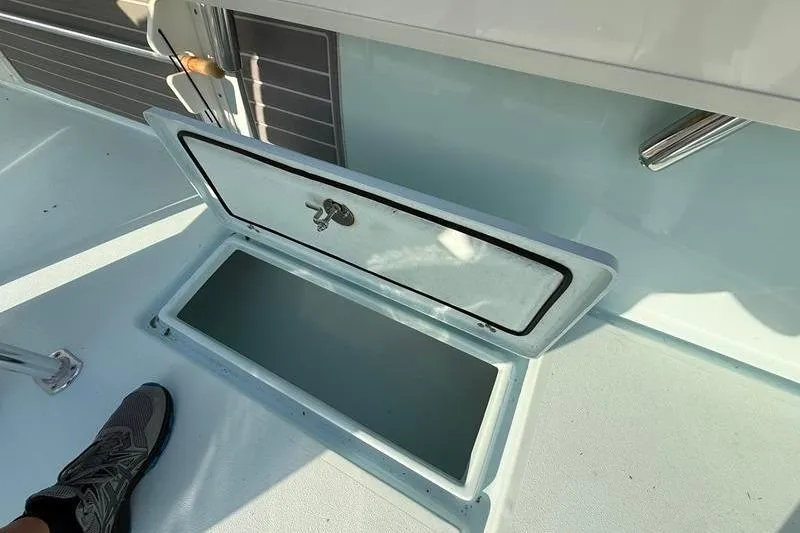 Slide: The Image of Open storage compartment on 2023 Pair Customs 24 Center Console DV boat. - 14