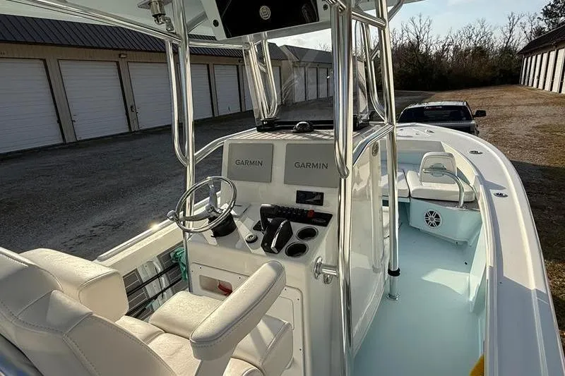 Slide: The Image of 2023 Pair Customs 24 Center Console DV boat interior with Garmin displays and seating. - 15