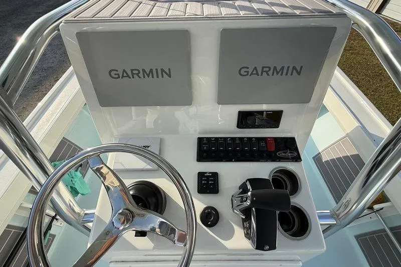 Slide: The Image of 2023 Pair Customs 24 Center Console DV dashboard with dual Garmin displays and controls. - 19
