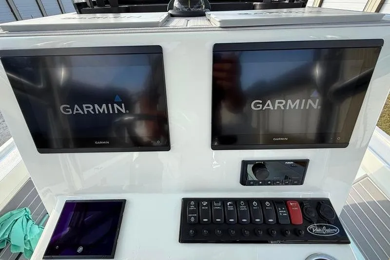 Slide: The Image of 2023 Pair Customs 24 Center Console DV with dual Garmin displays and control panel. - 22