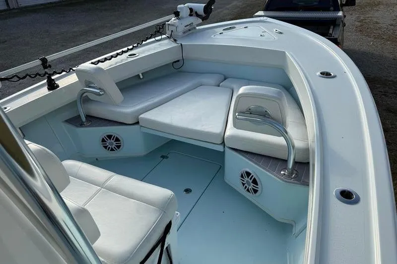 Slide: The Image of 2023 Pair Customs 24 Center Console DV boat interior with white seating and speakers. - 25
