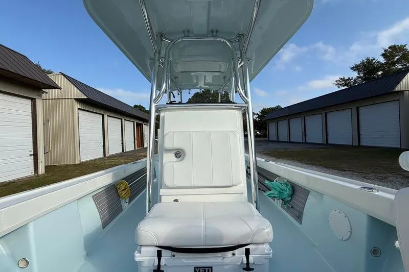 Slide: The Image of 2023 Pair Customs 24 Center Console DV boat interior with white seating and storage buildings. - 29