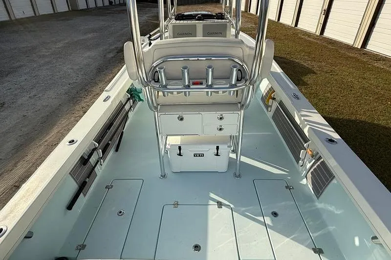 Slide: The Image of 2023 Pair Customs 24 Center Console DV boat interior with storage and seating. - 9