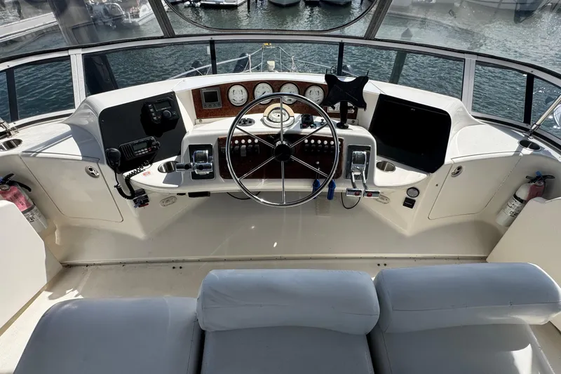Slide: The Image of Cockpit of 2003 Silverton 43 Motor Yacht with steering wheel and control panel. - 14
