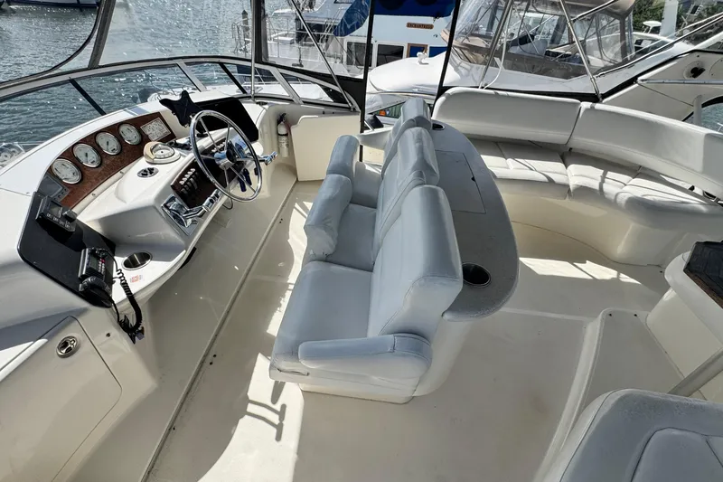 Slide: The Image of 2003 Silverton 43 Motor Yacht interior with helm, seating, and dashboard view. - 17
