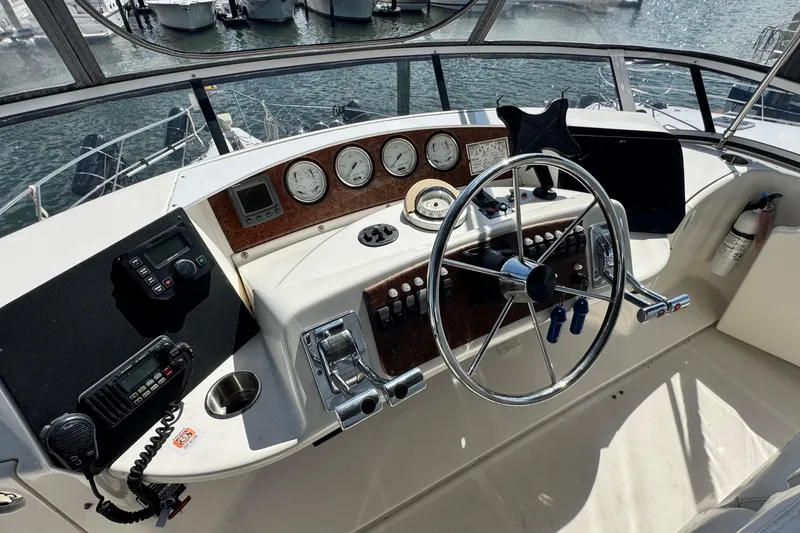 Slide: The Image of Helm of 2003 Silverton 43 Motor Yacht with steering wheel and control panel. - 18
