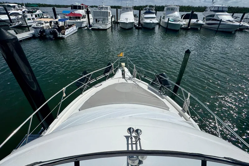Slide: The Image of 2003 Silverton 43 Motor Yacht docked at marina with other boats. - 21