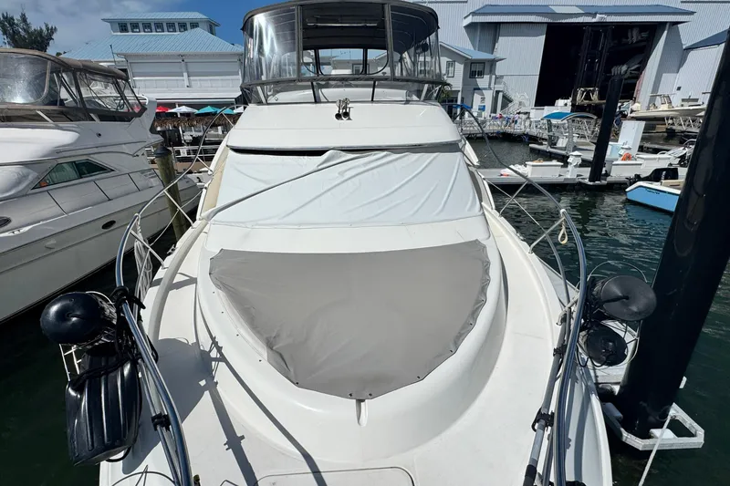 Slide: The Image of 2003 Silverton 43 Motor Yacht docked at marina, covered and ready for sailing. - 23