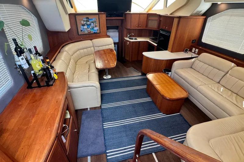 Slide: The Image of Luxurious interior of a 2003 Silverton 43 Motor Yacht with elegant seating and wooden finishes. - 25