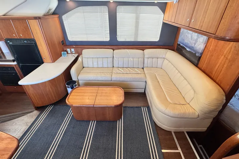 Slide: The Image of Luxurious interior of a 2003 Silverton 43 Motor Yacht with leather seating and wooden cabinetry. - 26