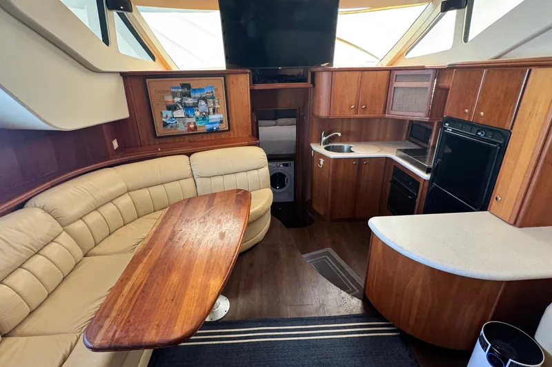 Slide: The Image of Interior of 2003 Silverton 43 Motor Yacht with kitchen and seating area. - 28