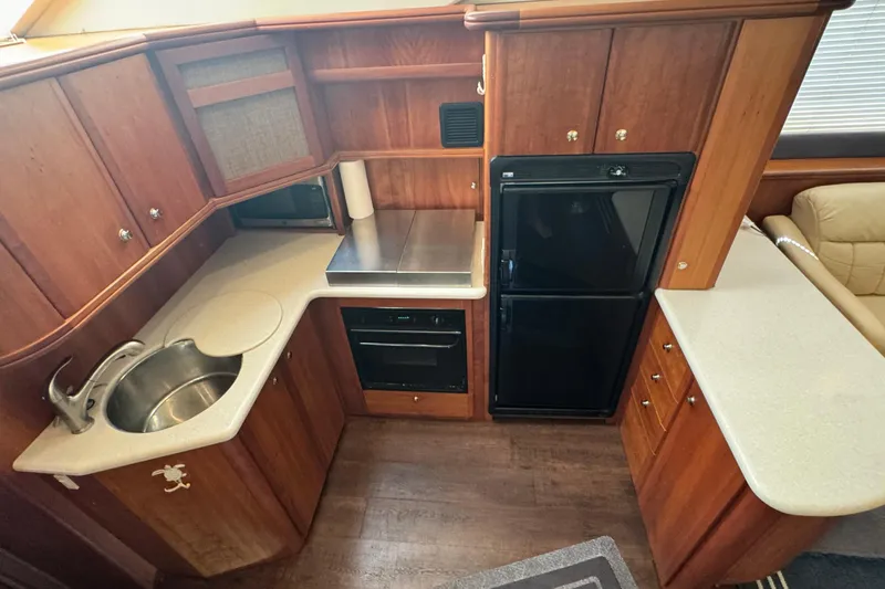 Slide: The Image of 2003 Silverton 43 Motor Yacht kitchen with wood cabinetry and modern appliances. - 31