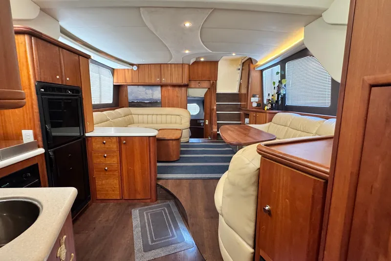 Slide: The Image of Luxurious interior of a 2003 Silverton 43 Motor Yacht with elegant wood finishes. - 32