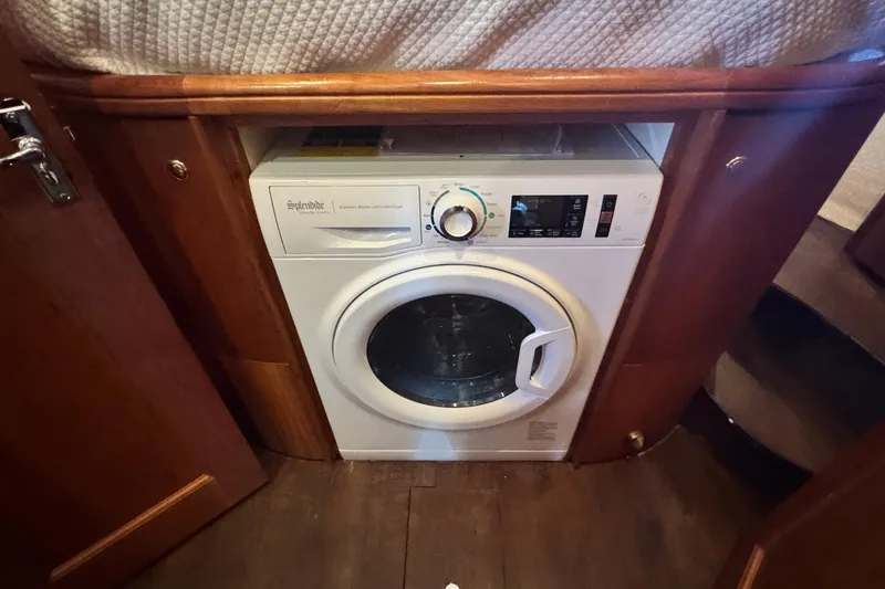 Slide: The Image of Built-in washer-dryer on 2003 Silverton 43 Motor Yacht, wooden cabinetry. - 33