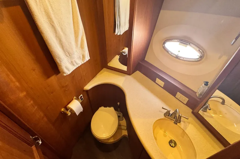 Slide: The Image of Bathroom interior of 2003 Silverton 43 Motor Yacht with sink and porthole window. - 35