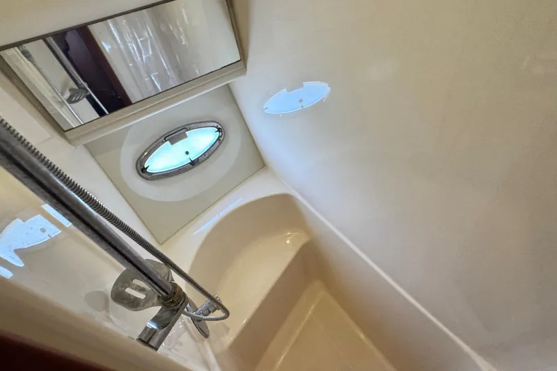 Slide: The Image of Bathroom interior of 2003 Silverton 43 Motor Yacht with shower and porthole window. - 36