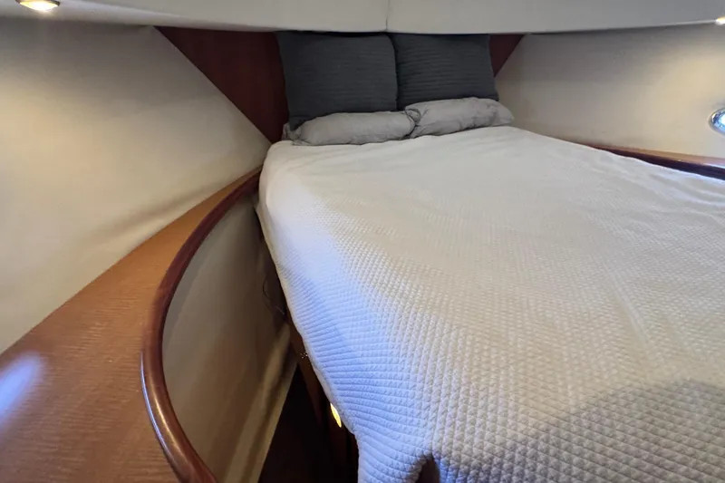 Slide: The Image of Cozy bedroom interior of 2003 Silverton 43 Motor Yacht with elegant wood accents. - 37