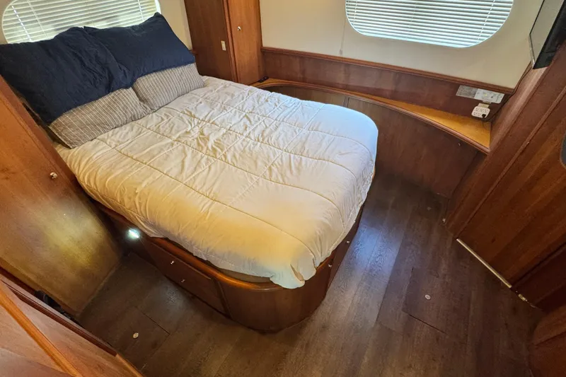 Slide: The Image of Interior cabin of 2003 Silverton 43 Motor Yacht with bed and wooden furnishings. - 38