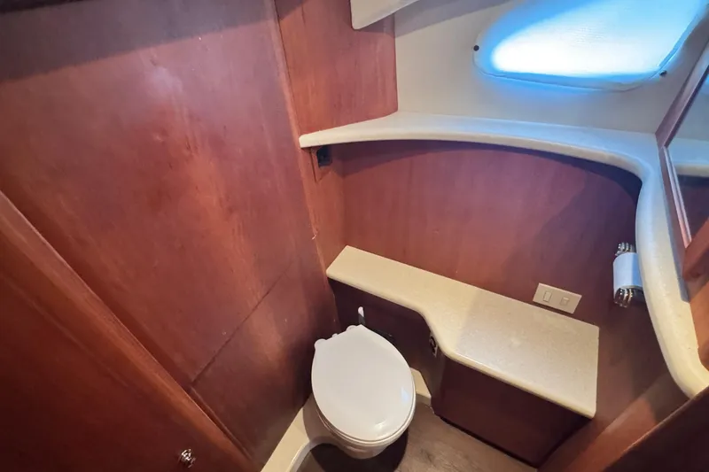 Slide: The Image of Bathroom interior of 2003 Silverton 43 Motor Yacht with wooden cabinetry and modern fixtures. - 39
