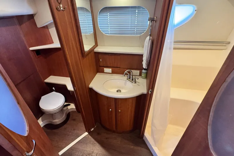 Slide: The Image of Luxurious bathroom in 2003 Silverton 43 Motor Yacht with sink, toilet, and shower. - 42