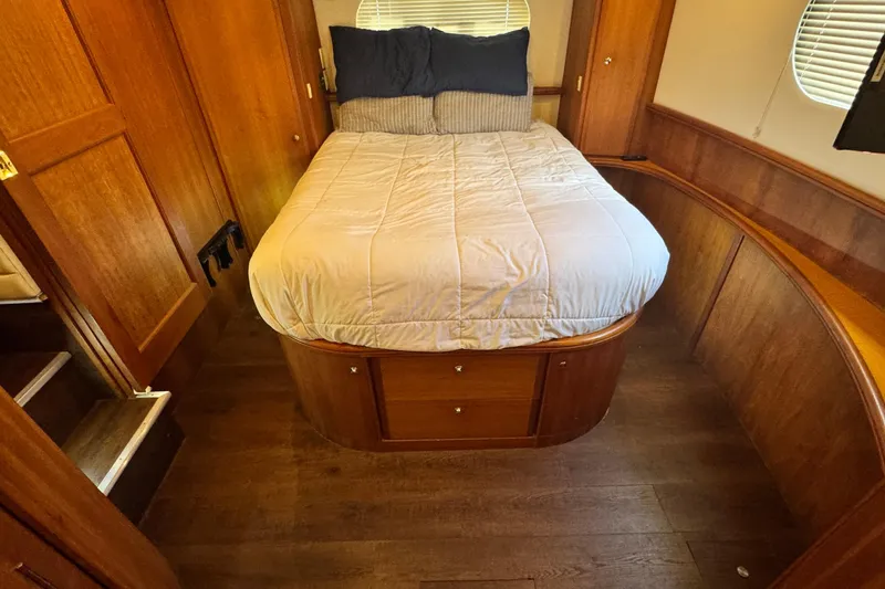 Slide: The Image of Cozy bedroom in 2003 Silverton 43 Motor Yacht with wooden interior and comfortable bedding. - 46
