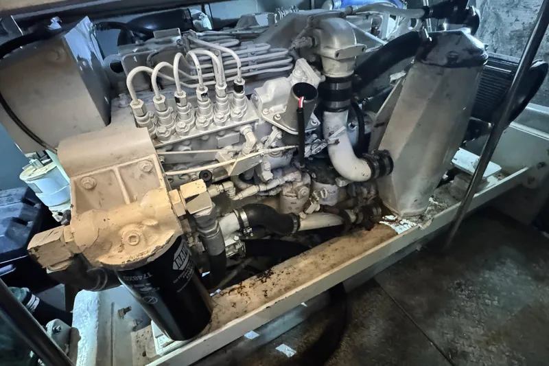Slide: The Image of Engine of a 2003 Silverton 43 Motor Yacht, showcasing intricate mechanical components. - 47