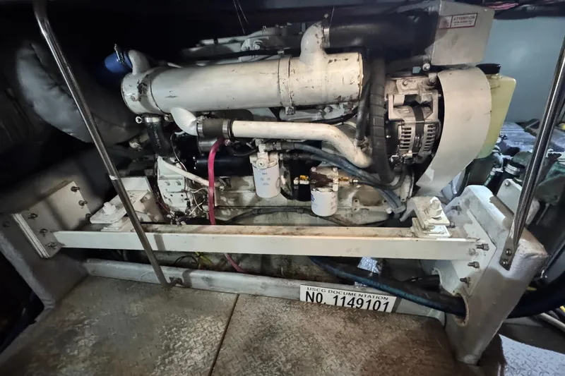 Slide: The Image of Engine room of a 2003 Silverton 43 Motor Yacht, showcasing mechanical components. - 48