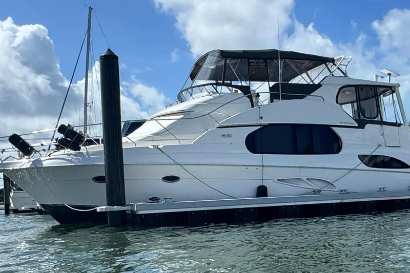 Slide: The Image of 2003 Silverton 43 Motor Yacht docked under a blue sky. - 5