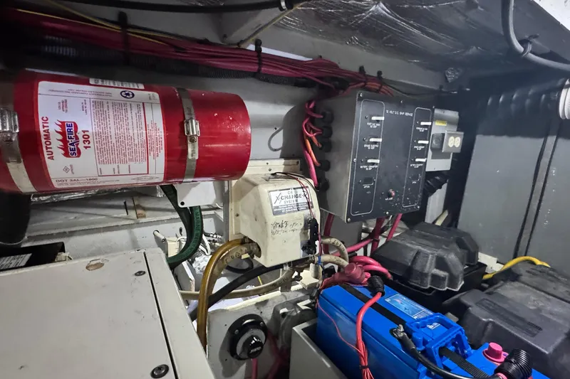 Slide: The Image of Engine room of 2003 Silverton 43 Motor Yacht with fire extinguisher and electrical components. - 50